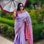 A luxurious silk saree in soft light purple, accentuated with a rich magenta border. Designed to turn heads at weddings, festive occasions, or any special moment.