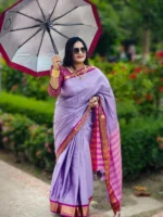 A luxurious silk saree in soft light purple, accentuated with a rich magenta border. Designed to turn heads at weddings, festive occasions, or any special moment.