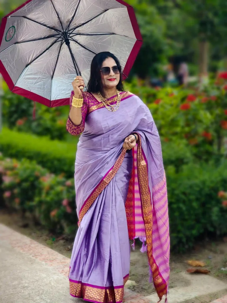 A luxurious silk saree in soft light purple, accentuated with a rich magenta border. Designed to turn heads at weddings, festive occasions, or any special moment.