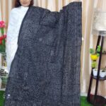 White hand stitching black fabric